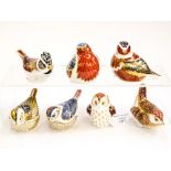 A collection of seven Royal Crown Derby paperweights including Collectors Guild Crested Tit, Owlet,