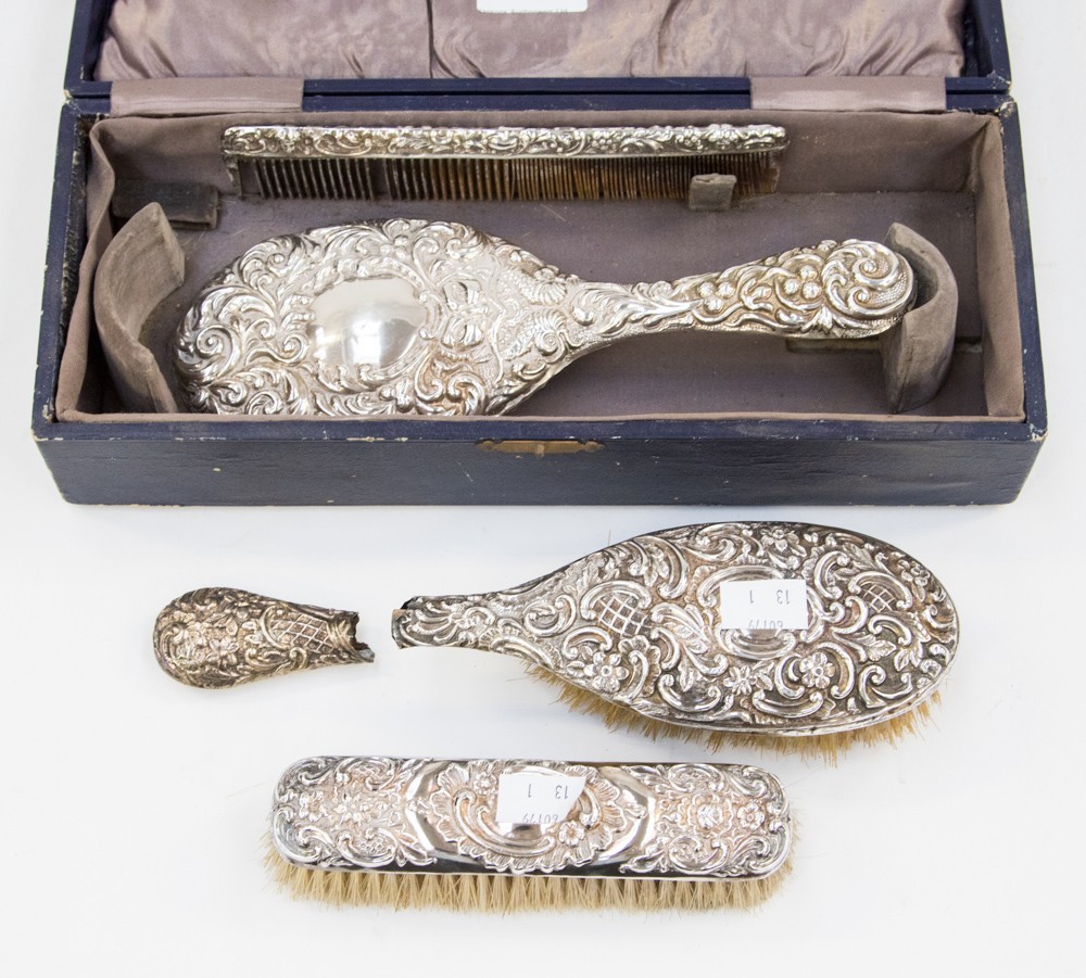 A cased embossed silver four piece dressing table set,