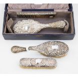 A cased embossed silver four piece dressing table set,