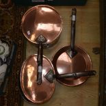 Three various copper pans with iron handles, all 19th Century,