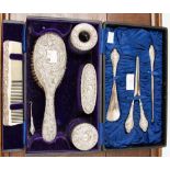 A George V silver toilet set, in leather case, embossed foliate scroll design, including brush,