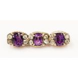 An amethyst and diamond bar brooch, rose metal and silver mounts,
