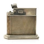 An Art Deco engine turned white metal and chrome table lighter by Rowenta