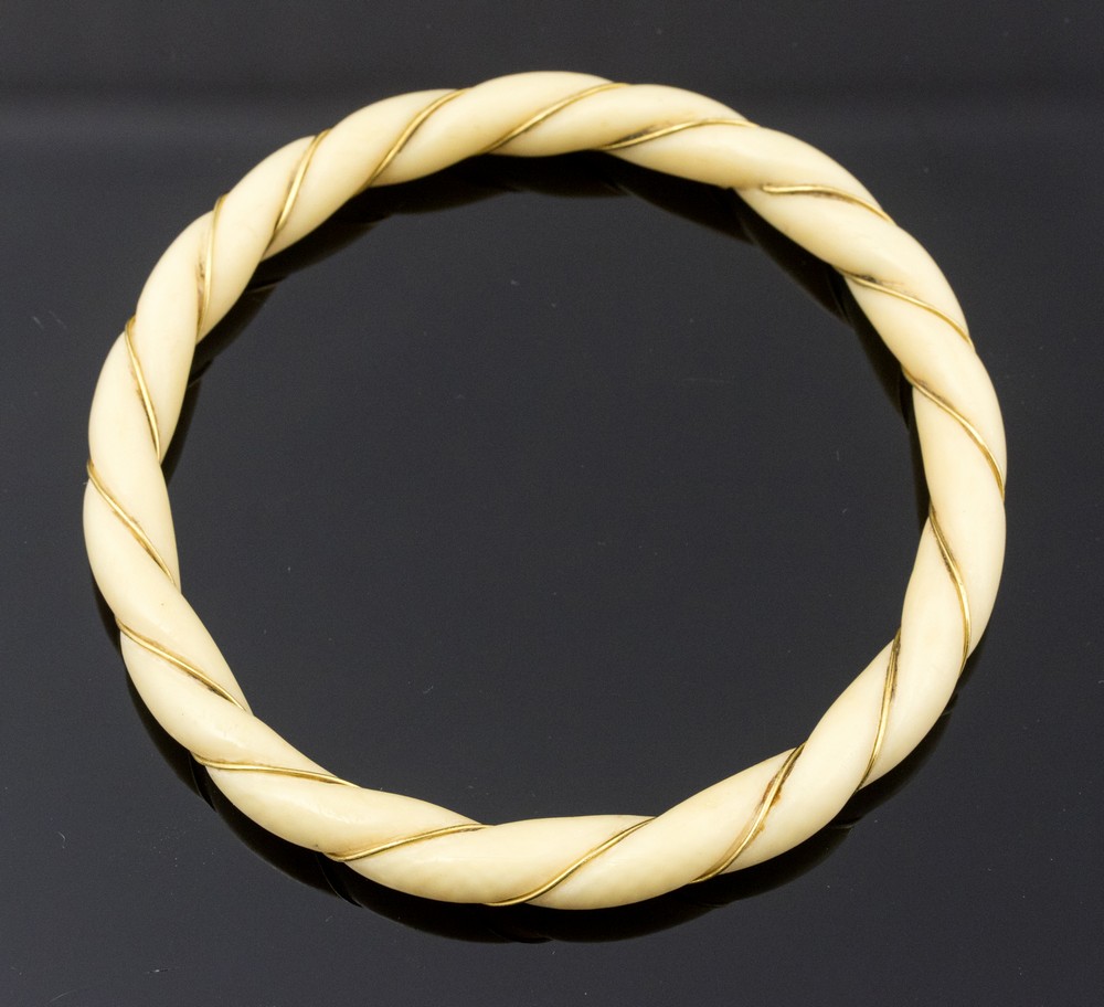 A 1920s ivory and gold thread bangle, ropetwist design, 6.5cm inner diameter, 7.