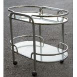A 1970s glass and chrome two-tier drinks trolley