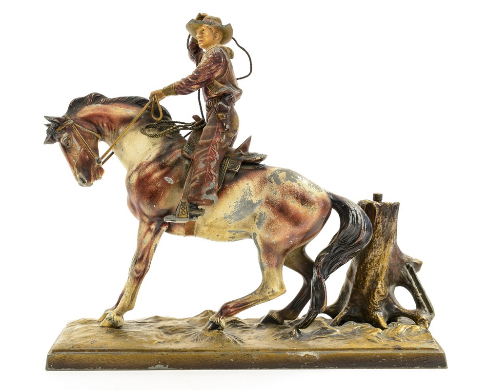 An Art Deco cold painted figural table lighter in the form of a Cowboy on Horse