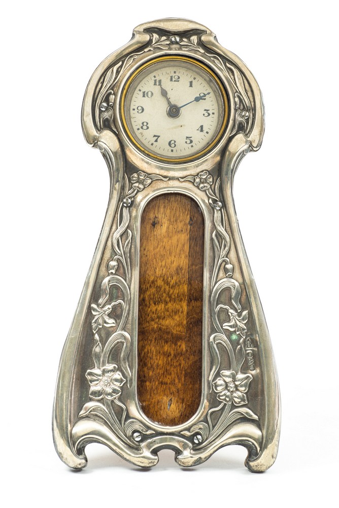 An Arts and Crafts silver timepiece photograph frame, in the Art Nouveau style,