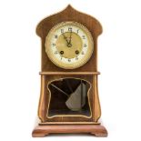 An Edwardian Art Nouveau style beach and mahogany cased eight day mantle clock,