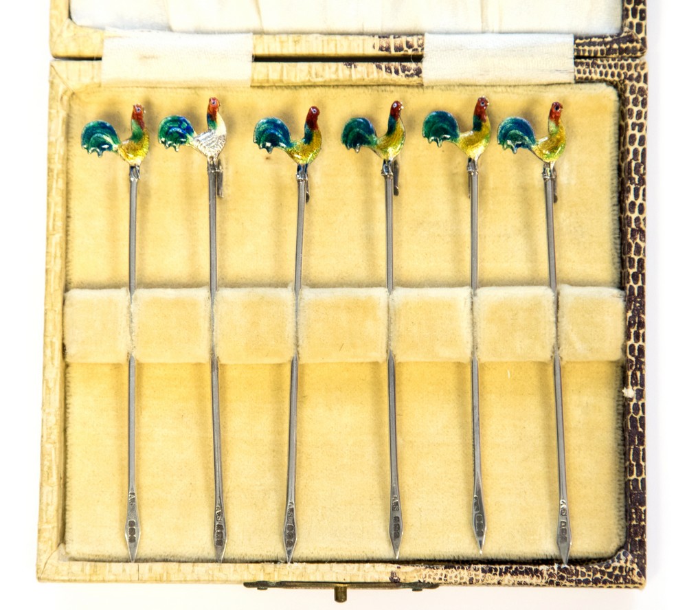 A set of Art Deco silver and enamelled cocktail sticks,