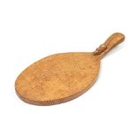 Robert 'Mouseman' Thompson of Kilburn, an Arts and Crafts oak cheese board, with handle,