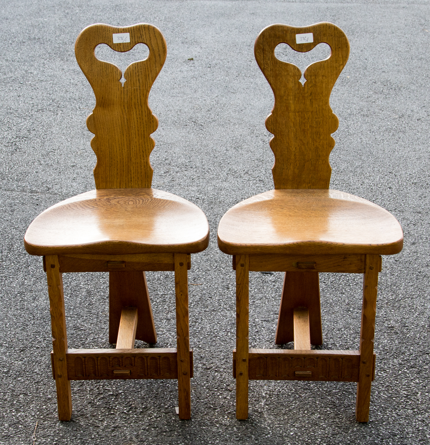 Rupert Griffiths, an Arts and Crafts, Cotswold School, a set of six carved oak dining chairs,