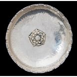 Omar Ramsden, an Arts and Crafts silver dish, shallow, planished form with denticulated fluted rim,