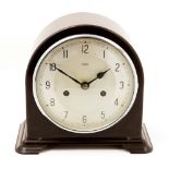 An Art Deco Enfield bakelite mantle clock, domed form, brown marble effect case,