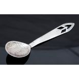 A white metal Scottish Arts and Crafts caddy or preserve spoon, pierced geometric terminal,