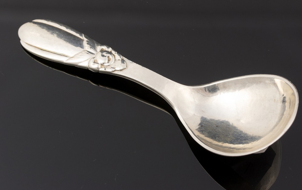 Evald Nielsen, a Danish silver cady spoon, 1927, hand hammered with stylised floral motif, 10.