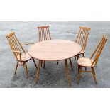 An Ercol light elm and ash dropleaf dining table, circular form on tapered legs, 113cm diameter,