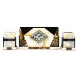 An Art Deco marble clock garniture, rectangular form with geometric panels of black,