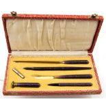 An Art Deco pen set, aventurine included purple resin,