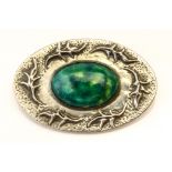 An Arts and Crafts Ruskin type pewter brooch, the oval cabouchon plaque,