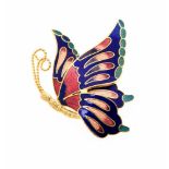 A gilt metal enamelled butterfly brooch, modelled in flight, blue, green and red enamel,