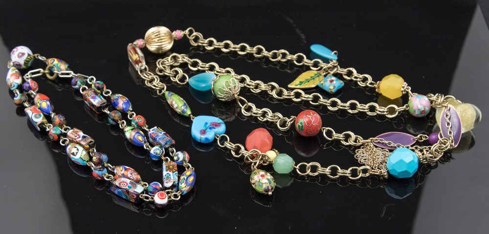 A 1960s candy charm necklace with various Murano enamelled metal and resin beads on gilt chain,