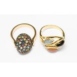 A three stone gold plated ring plus another gem set ring,