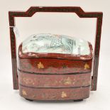 A 20th Century Chinese ceramic and lacquer food storage container with three layers and handle
