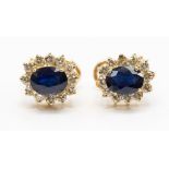 A pair of sapphire and diamond earrings, in 14ct gold on Omega pin and clip fittings,