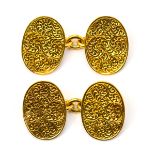 A pair of Victorian 15ct gold cufflinks, the oval terminals engraved leafage scrolls,