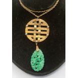 A carved jadeite type and paste yellow metal drop pendant necklace,