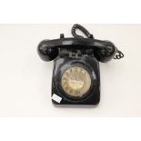 A 1960s black plastic spin dial telephone