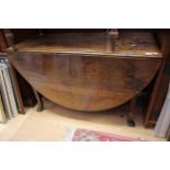 A George III oak drop leaf table,