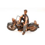 A figurine of a man mounted on a motorcycle