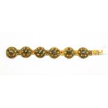 A 19th century cannetille work six link multi gemstone set bracelet with each link having flower