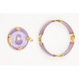 A 14k gold and lavender jade circular pendant; together with a 14k bracelet ensuite,