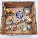 A collection of ten bisque Royal Worcester models of birds together with a Beswick model of a blue