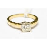A champagne princess cut diamond solitaire yellow metal ring,