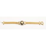 An 18ct gold mesh braclet with onyx centre detail, with a white stone surround, both clasps fastens,