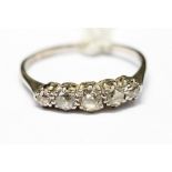 A diamond and platinum five stone ring, claw set with old cut diamonds, size Q,