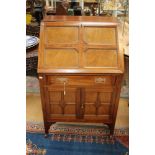 An early 20th century mahogany bureau, the fall front enclosing a fitted interior,