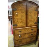 A Queen Anne style walnut side cupboard, the upper section with two doors enclosing fitted shelves,