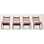 A set of four oak dining chairs, each with a fluted cresting and two back rails,
