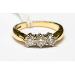 A diamond and 18ct yellow gold three stone ring, total diamond weight approximately one carat,