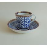 A Worcester Flight coffee cup and saucer, decorated in the Queen Charlotte Royal Lilly Pattern,