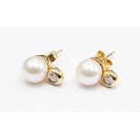 A pair of pearl and diamond 18ct gold earrings, total diamond weight approx 0.