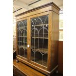 An early 20th Century oak two-door bookcase,