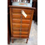 An early 20th Century oak seven drawer chest,