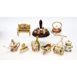 A group of Royal Crown Derby miniature items: Watering Can, Bench, Lawn Roller, Milk Churn, etc,