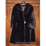 A ladies fur coat in dark brown beaver lamb