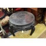 A Chinese hardwood circular table, the top with a Greek Key pattern, carved and pierced frieze,
